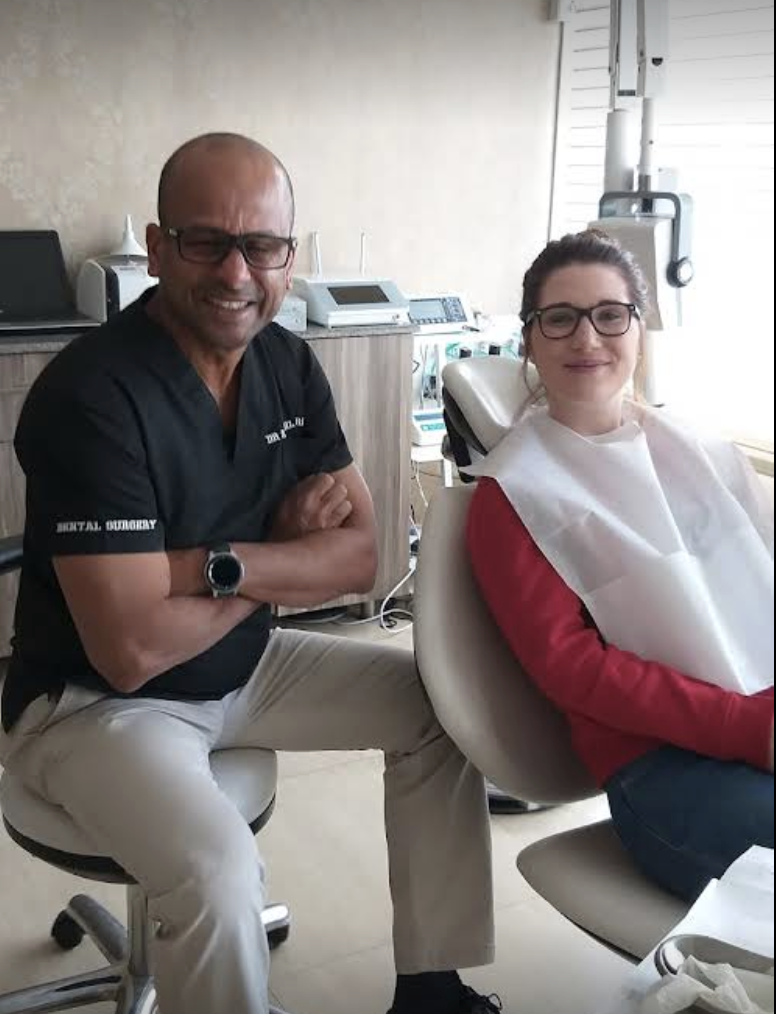 Dr. Parambi with patient in dental chair